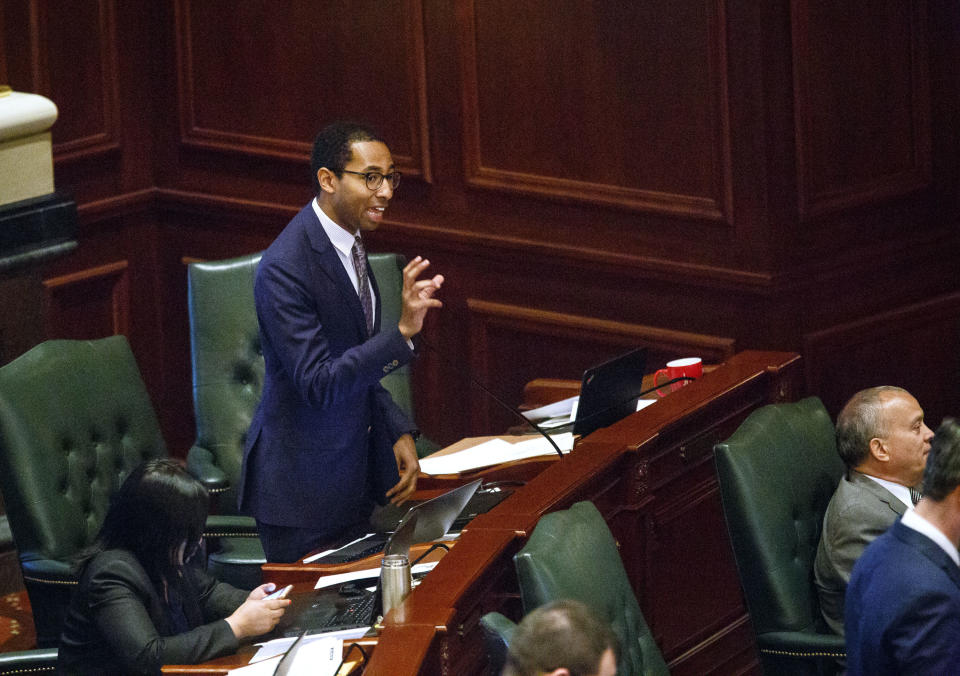 FILE - In this May, 31, 2017, file photo, Rep. Christian Mitchell, D-Chicago, speaks on the House floor at the Capitol in Springfield, Ill. A unique provision in Illinois’ newly minted law legalizing marijuana allows expungement of criminal records for anyone convicted of purchase or possession of one ounce (30 grams) or less of marijuana, a group of nearly 800,000 people. (Rich Saal/The State Journal-Register via AP, File)