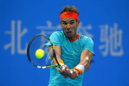 Rafael Nadal of Spain returns a shot to Peter Gojowczyk of Germany during their men's singles match at the China Open tennis tournament in Beijing October 2, 2014. REUTERS/Petar Kujundzic