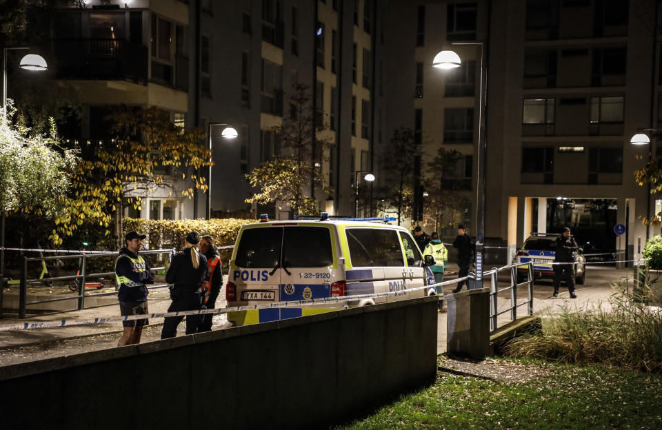 Ambulance and police stand at the scene where Swedish rapper Einar was shot to death, in Hammarby Sjostad district in Stockholm, early Friday, Oct. 22, 2021. An award-winning 19-year-old Swedish rapper was shot to death in southern Stockholm in an incident that media reports on Friday suggested could be gang-related. The rapper Einar was struck by several bullets in the Hammarby suburb south of central Stockholm and died on the spot late Thursday, police spokesman Ola Osterling told the Swedish news agency TT. (Christine Olsson/TT via AP)