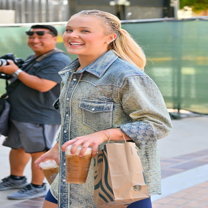 jojo walking with starbucks coffee