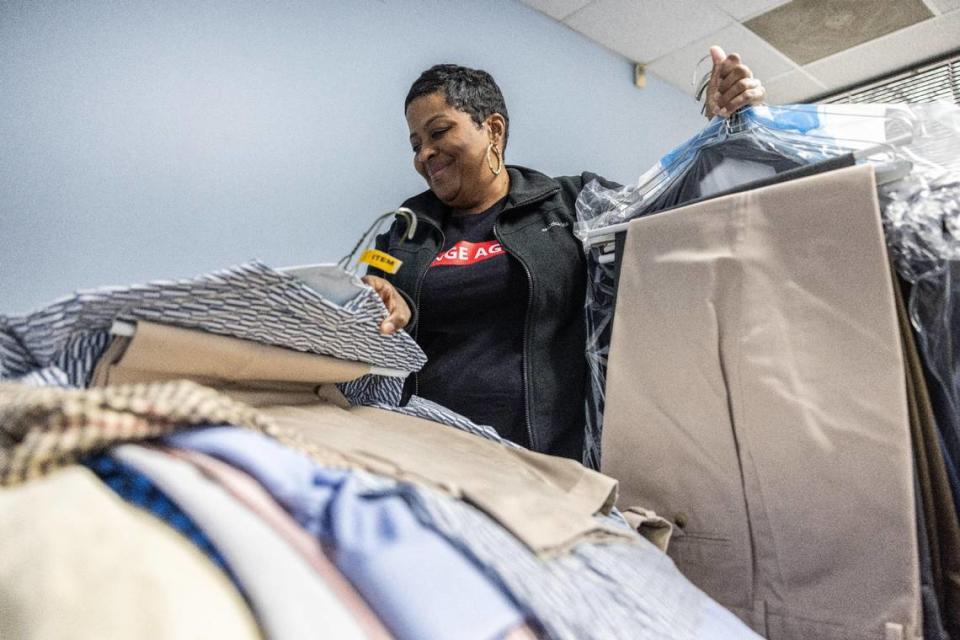 Traletta Banks, who heads Erika’s Closet in Charlotte N.C., looks through clothes that were donated on Monday, March 13, 2023. Robinson coordinates with other nonprofits, such as Erika’s Closet, to better assist individuals with reentry.