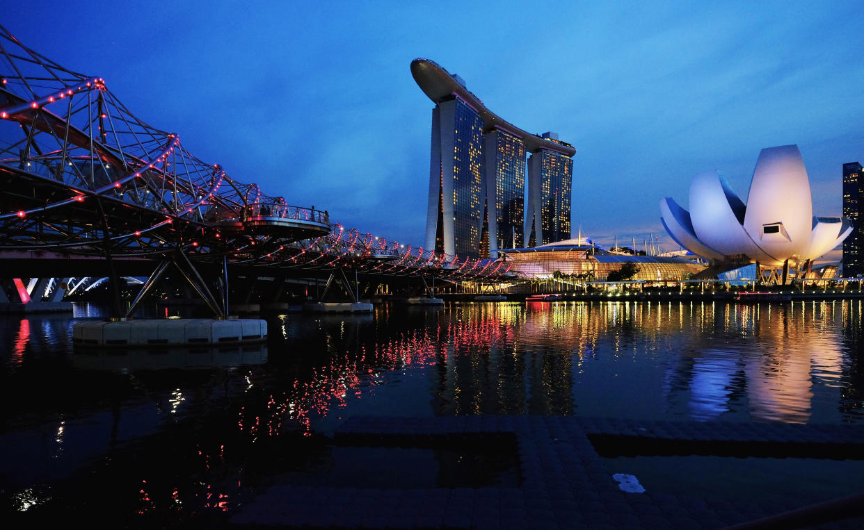 The Helix Bridge is seen next to the Marina Bay Sands integrated resort, during dusk in the central business district of Singapore, November 13, 2018. REUTERS/Kevin Lam