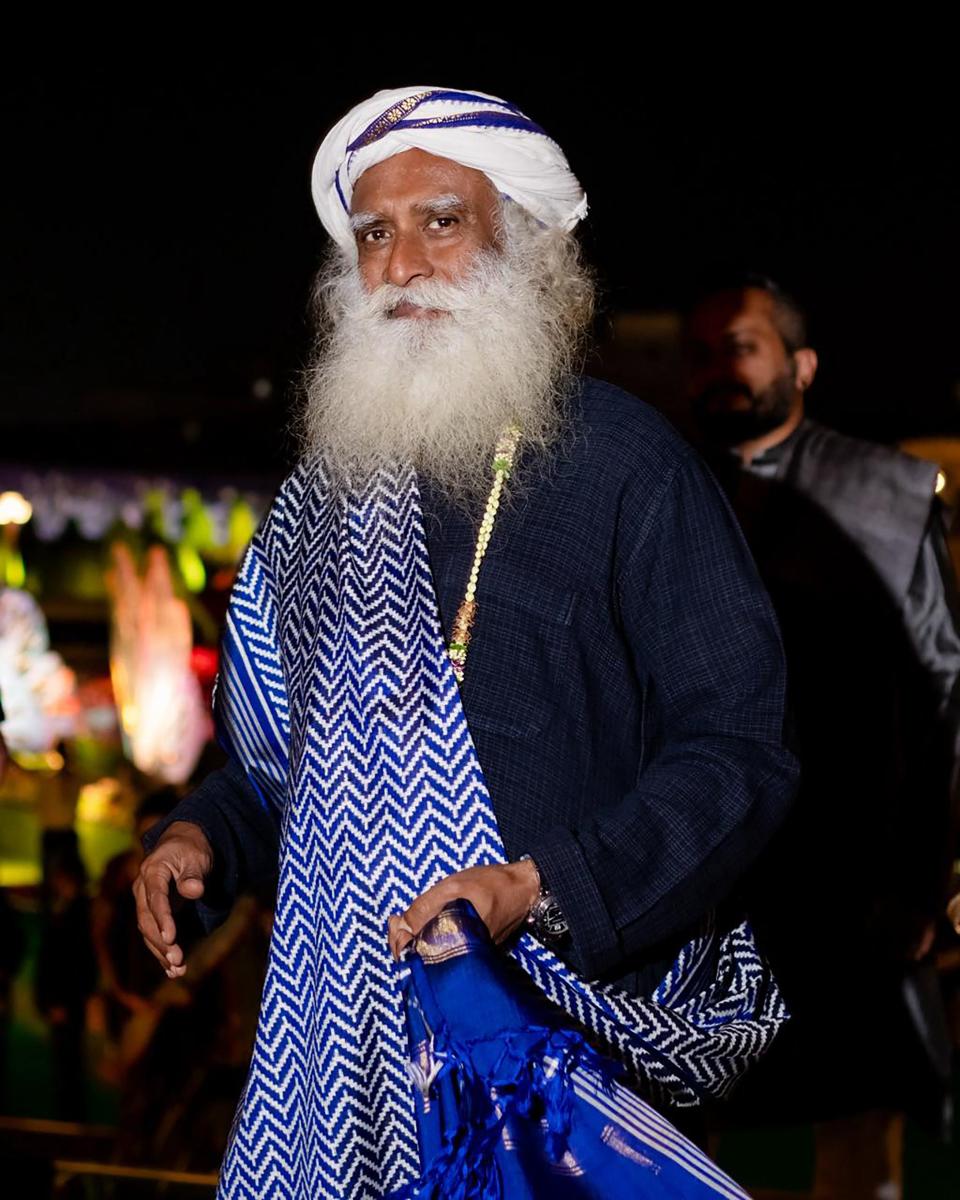 This handout photograph taken and released by Reliance on March 1, 2024, shows India's spiritual guru and founder of Isha Foundation, Jagadish "Jaggi" Vasudev, popularly known as Sadhguru attending a three-day pre-wedding celebration hosted by billionaire tycoon Mukesh Ambani, for his son Anant Ambani and Radhika Merchant in Jamnagar.