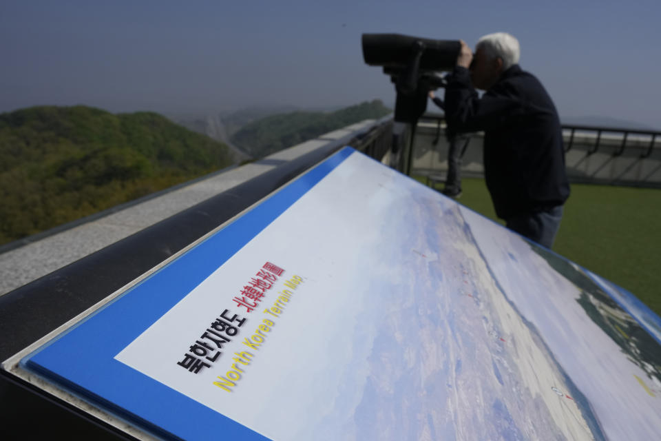 A visitor uses binoculars to see the North Korean side from the unification observatory in Paju, South Korea, Wednesday, April 19, 2023. North Korean leader Kim Jong Un said his country has completed the development of its first military spy satellite and ordered officials to go ahead with its launch as planned, state media reported Wednesday. (AP Photo/Lee Jin-man)