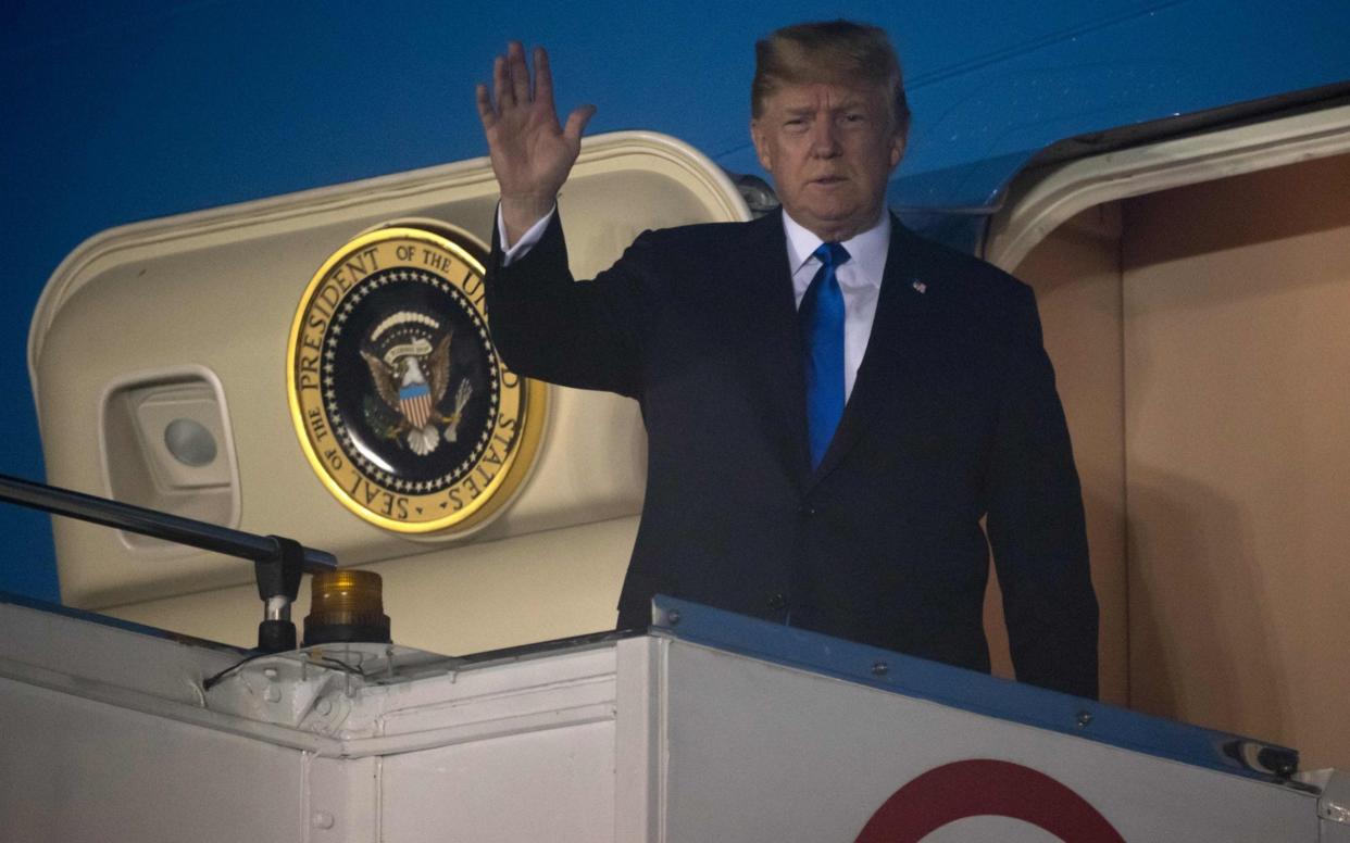  Donald Trump waves after Air Force One arrived at Paya Lebar Air Base in Singapore - AFP