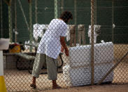 GUANTANAMO BAY, CUBA - JANUARY 21: (NOTE TO EDITORS: PHOTO HAS BEEN REVIEWED BY US MILITARY OFFICIALS) A Guantanamo detainee opens a cooler inside the open yard at Camp 4 detention center at the U.S. Naval Base January 21, 2009 in Guantanamo Bay, Cuba. The Guantanamo Bay war crimes court came to an abrupt halt today as military judges granted President Barack Obama's request to suspend proceedings while he reviews his predecessor's strategy for prosecuting terrorists. (Photo by Brennan Linsley-Pool/Getty Images)