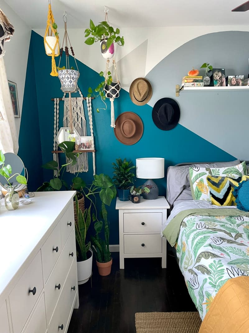 Hats hanging in colorful bedroom.