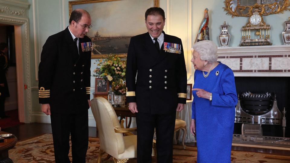 Queen Elizabeth II receives outgoing Commanding Officer, HMS Queen Elizabeth, Commodore Steven Moorhouse (C)  and incoming Commanding Officer, Captain Angus Essenhigh (L) during a private audience in the Queen's Private Audience Room