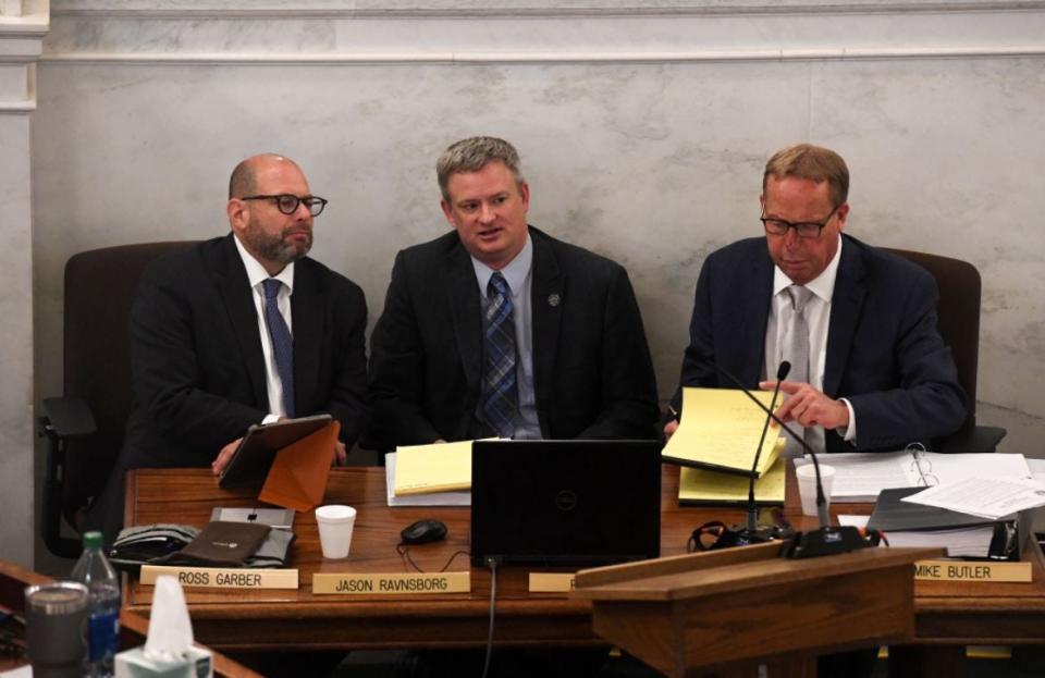 Attorney General Jason Ravnsborg, center, appears for the first day of his impeachment trial on Tuesday, June 21, 2022, at the South Dakota State Capitol in Pierre. Lawyers Ross Garber and Mike Butler sit alongside him at the defense table.