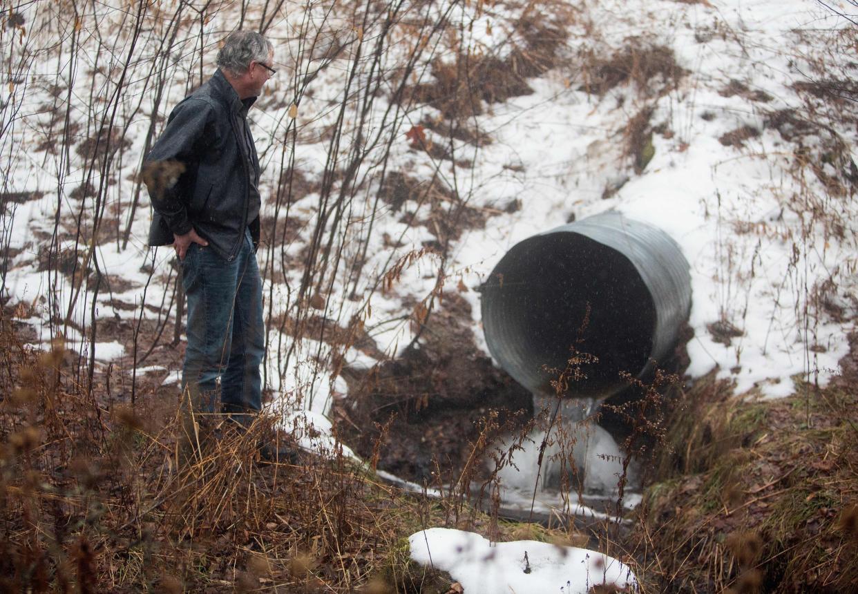 David Huff, chair of the zoning and planning commission for Osceola Township, stands before Chippewa Creek, shown flowing through a culvert where global food conglomerate Nestle is in a battle with critics in the tiny town over its water extraction.