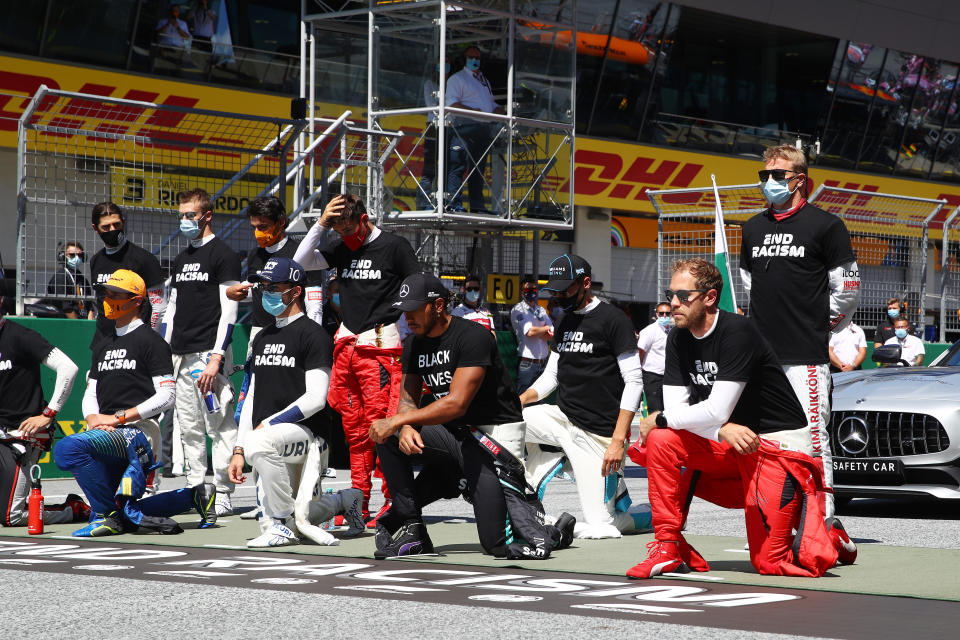 SPIELBERG, AUSTRIA - JULY 05: Lewis Hamilton of Great Britain and Mercedes GP and some of the F1 drivers take a knee on the grid in support of the Black Lives Matter movement ahead of the Formula One Grand Prix of Austria at Red Bull Ring on July 05, 2020 in Spielberg, Austria. (Photo by Mark Thompson/Getty Images)
