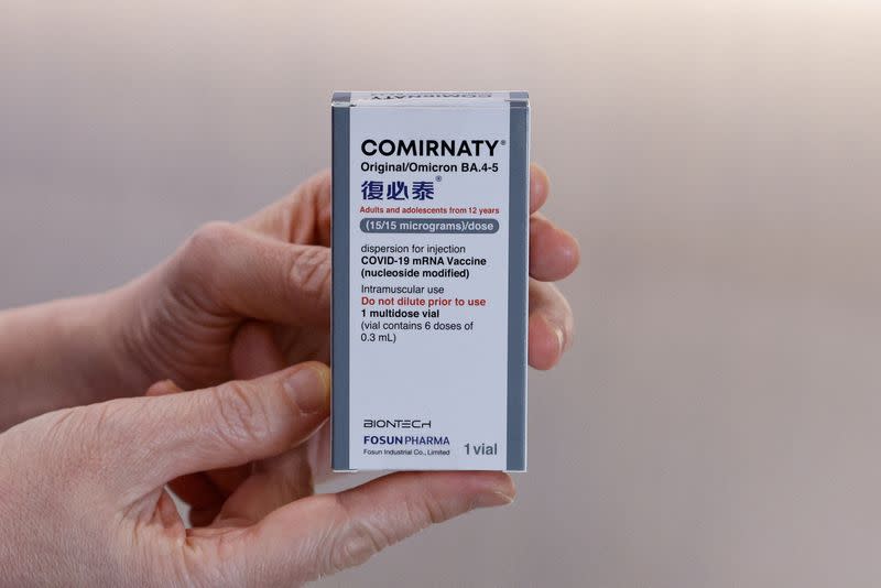 A nurse holds a box of BioNTech bivalent coronavirus disease (COVID-19) vaccine at a private clinic in Hong Kong