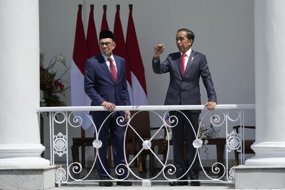 Indonesian President Joko Widodo, right, gestures as he talks with Malaysian Prime Minister Anwar Ibrahim during their meeting at the presidential palace in Bogor, West Java, Indonesia, Monday, Jan. 9, 2023. (AP Photo/Achmad Ibrahim)