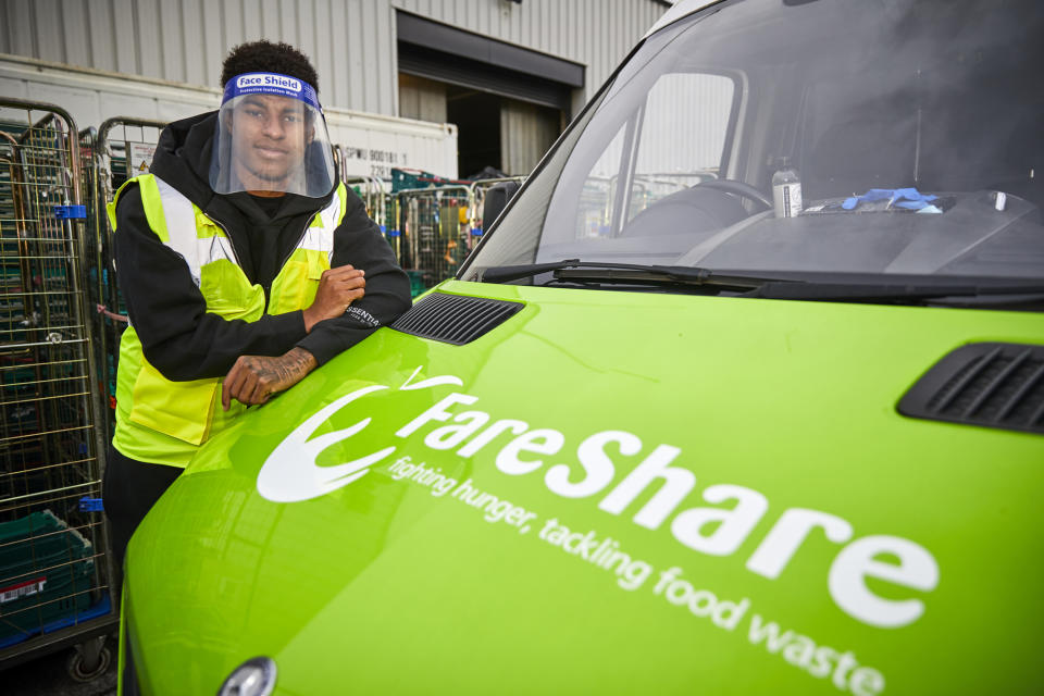 FILE - In this Thursday, Oct. 22, 2020 file photo, Manchester United player Marcus Rashford visits FareShare Greater Manchester at New Smithfield Market, Manchester, England. The British government has made another U-turn and now says it will provide free meals to disadvantaged children over upcoming holidays. That follows a hugely popular campaign to fight child hunger by Manchester United soccer star Marcus Rashford. British Prime Minister Boris Johnson phoned the 23-year-old striker after his team’s Premier League victory over Everton on Saturday, Nov. 7, 2020 to inform him of the decision. (Mark Waugh/FareShare via AP, File)