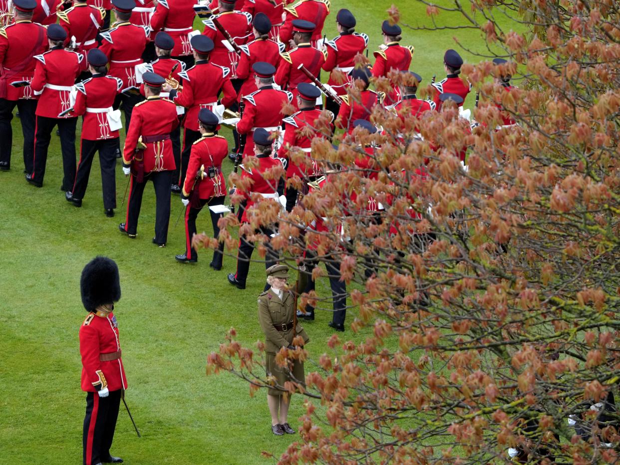Members of the armed forces march on the lawn outside Buckingham Palace (via REUTERS)