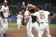 Baltimore Orioles pour water onto Ryan McKenna (65) after he drew a bases-loaded walk to drive in the winning run against the Miami Marlins in the ninth inning of a baseball game Wednesday, July 28, 2021, in Baltimore. (AP Photo/Terrance Williams)