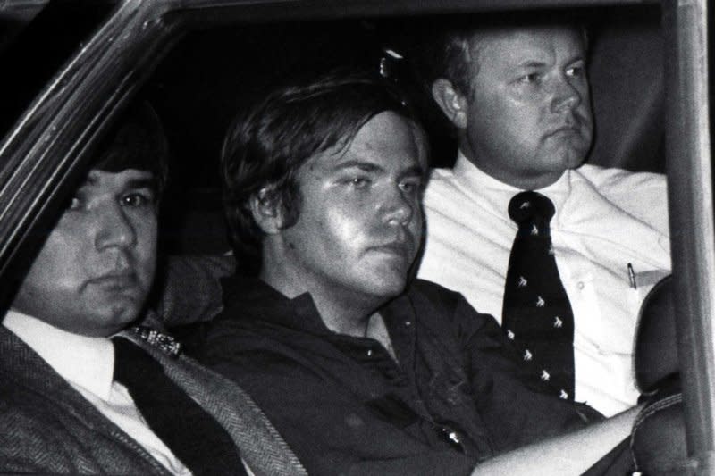 John Hinckley Jr. is flanked by federal agents as he is driven away from court April 10, 1981. On March 30, 1981, John Hinckley Jr. shot U.S. President Ronald Reagan outside a Washington hotel. UPI File Photo