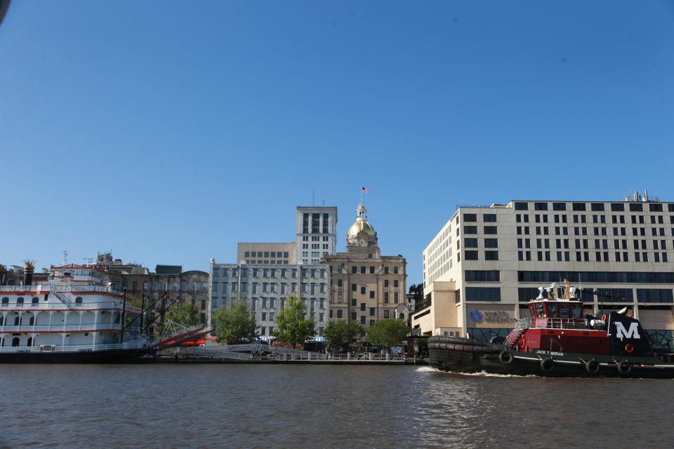 A tugboat passes the Hyatt as it motors along the Savannah River.