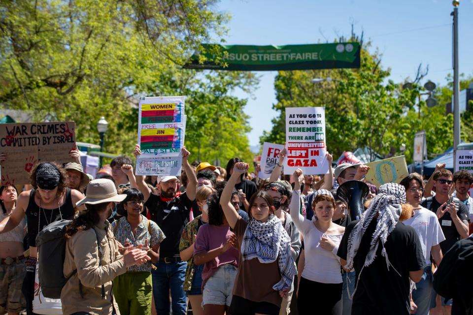 Pro-Palestinian protestors march through the ASUO Street Faire on the University of Oregon campus Friday, May 10, 2024, in support of a cease-fire in Gaza.