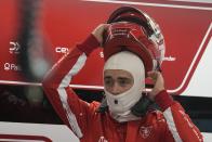 Ferrari driver Charles Leclerc, of Monaco, puts on his helmet during the final practice session for the Formula One Las Vegas Grand Prix auto race, Friday, Nov. 17, 2023, in Las Vegas. (AP Photo/Darron Cummings)