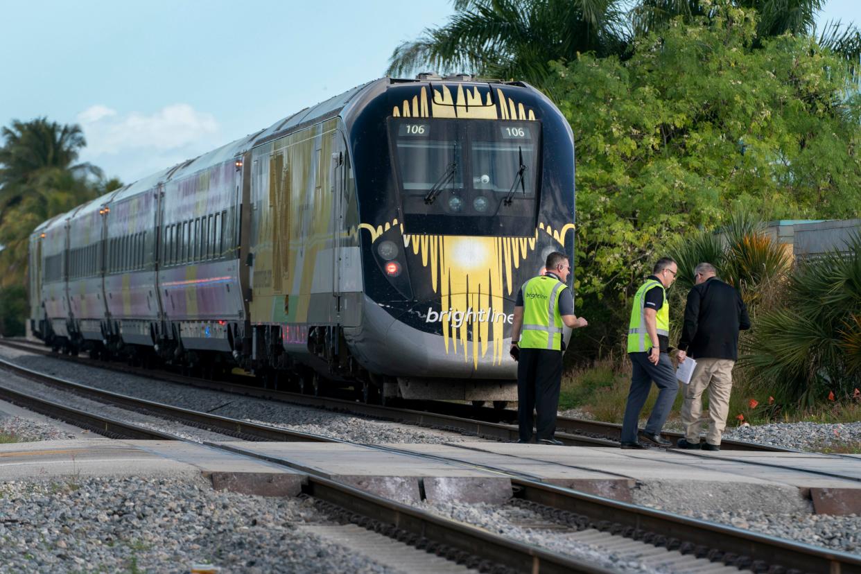 Official investigate the scene on the FEC tracks after a northbound Brightline train struck and killed a person near Northeast 13th Avenue in Boynton Beach, Florida on January 4, 2021.