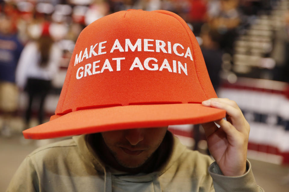 A supporter wears a large hat before a President Donald Trump's rally on Tuesday, Nov. 26, 2019, in Sunrise, Fla. (AP Photo/Brynn Anderson)