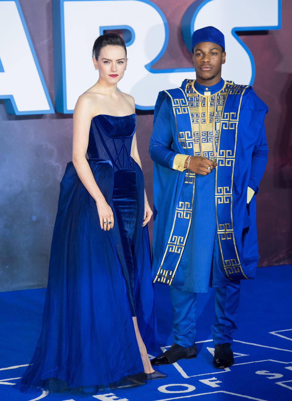 John Boyega, wearing traditional dress, and Daisy Ridley, in Vivienne Westwood Couture, at the 'Star Wars: The Rise of Skywalker' London premiere [Photo: Getty]