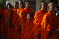 Cambodian Buddhist monks wait in queue to enter into the courtroom before the hearings against two former Khmer Rouge senior leaders, at the U.N.-backed war crimes tribunal on the outskirts of Phnom Penh, Cambodia, Friday, Nov. 16, 2018. The U.N.-backed tribunal judging the criminal responsibility of former Khmer Rouge leaders for the deaths of an estimated 1.7 million Cambodians will issue verdicts Friday in the latest — and perhaps last — of such trials. (AP Photo/Heng Sinith)