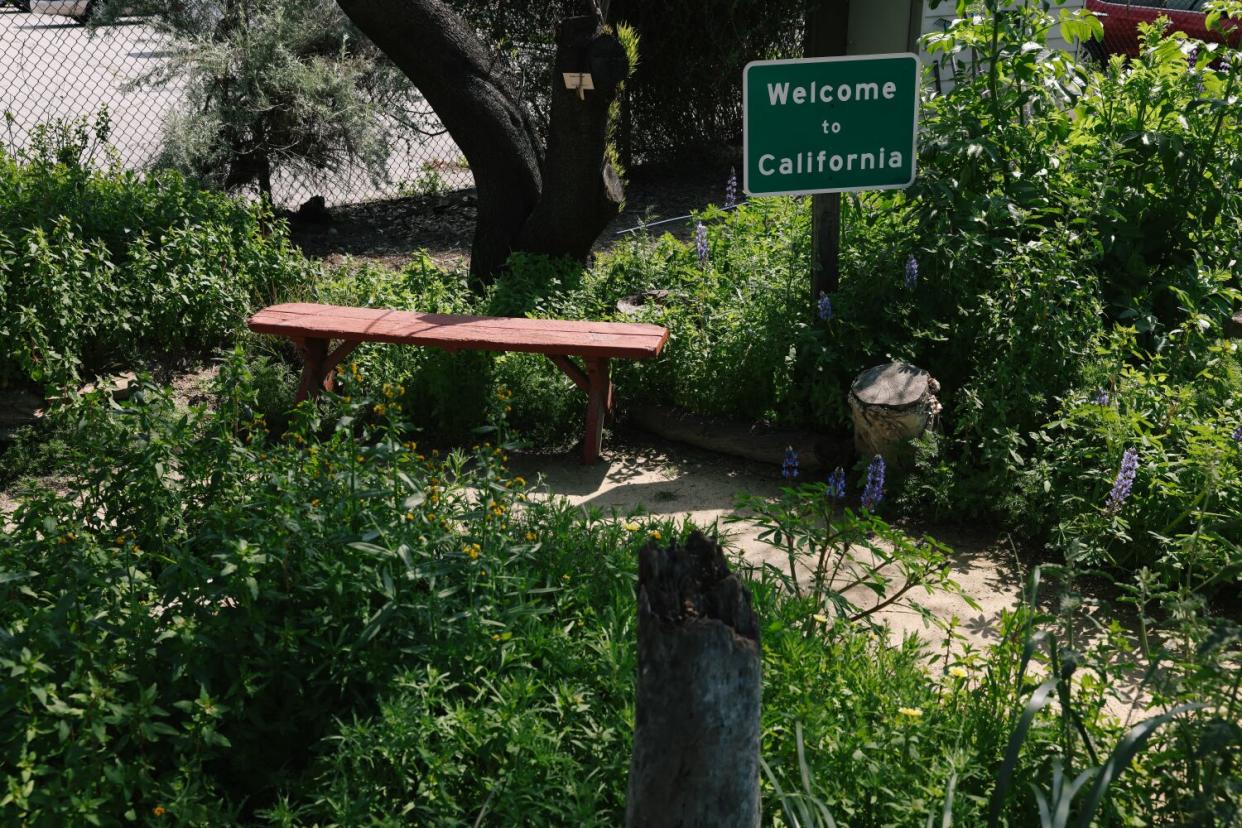 A 'Welcome to California' sign at a garden