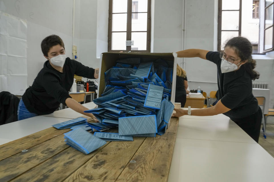 Scrutineers count ballots after the closing of a polling station, in Rome, Monday, Oct. 4, 2021. Ballot counting has begun in Italy following the end Monday of two days of voting for mayors in many cities. (AP Photo/Andrew Medichini)