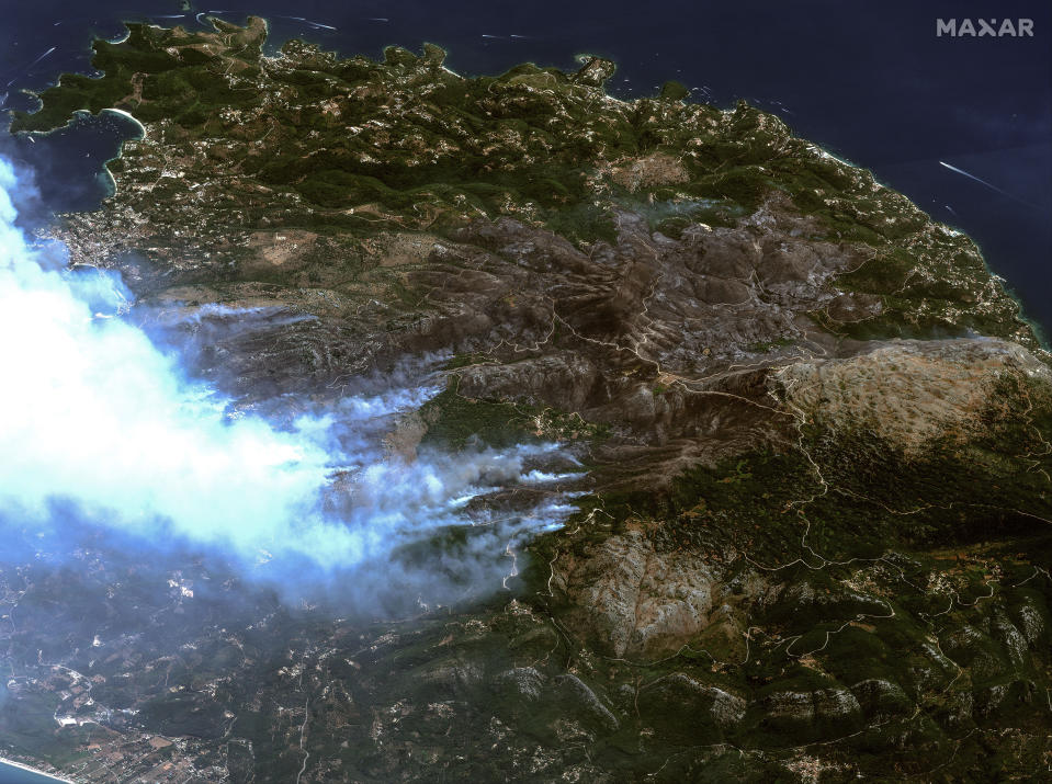 This image provided by Maxar Technologies, shows wildfires on the island of Corfu, Greece, Tuesday July 25, 2023. A third successive heat wave in Greece pushed temperatures back above 40 degrees Celsius (104 degrees Fahrenheit) across parts of the country Tuesday amid a string of evacuations from fires that have raged out of control for days. A fire service spokesman said the worst blazes were on the southeastern island of Rhodes and the northwestern island of Corfu. (Satellite image ©2023 Maxar Technologies via AP)