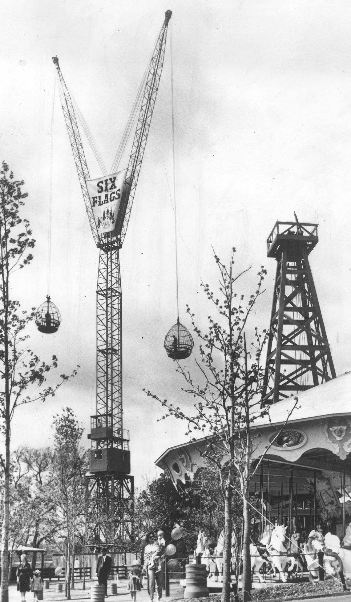 April 9, 1965: The 190-foot tall Sky Hook and merry-go-round (carousel) rides at the new 6-acre oil boom town section of Six Flags Over Texas, new for the season