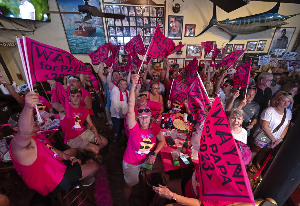 In this Saturday, July 22, 2023, photo provided by the Florida Keys News Bureau, fans of Wayne Collins cheer for their contestant as he competes in the annual Hemingway Look-Alike Contest at Sloppy Joe's Bar in Key West, Fla. The competition was a highlight of the annual Hemingway Days festival that ends Sunday, July 23. Ernest Hemingway lived in Key West throughout most of the 1930s. (Andy Newman/Florida Keys News Bureau via AP)