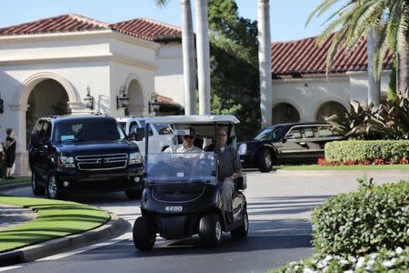 Security personnel drive a golf card at the Trump National Golf club where Japanese Prime Minister Shinzo Abe and U.S. President Donald Trump play golf in Jupiter, Florida, U.S., February 11, 2017. REUTERS/Carlos Barria
