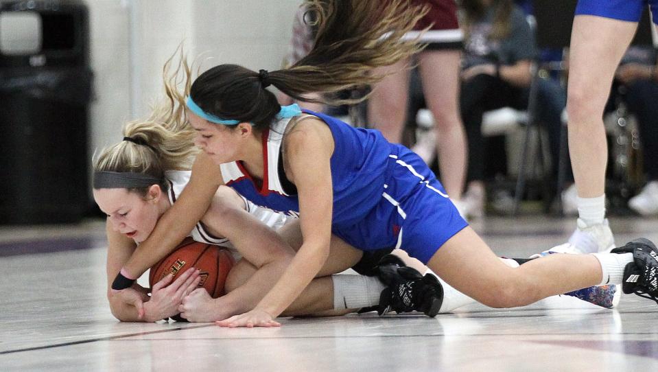 Salina Central's Aubrie Kierscht (35) and Andover's Amelya Vance (1) battle for the ball during their championship game of the Salina Invitational Tournament Saturday evening, Jan. 22, 2022. 