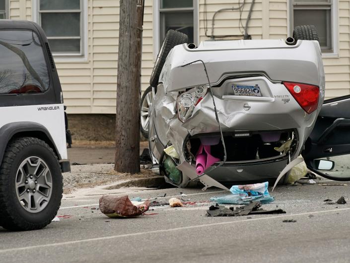 car flipped over and took out a utility pole on Main Street in South Portland after being stolen by a man who attempted to rob Town &amp; Country Credit Union in South Portland on Thursday, March 12, 2020.