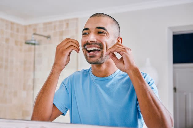 Flossing regularly can help improve your overall health. (Photo: Moyo Studio via Getty Images)