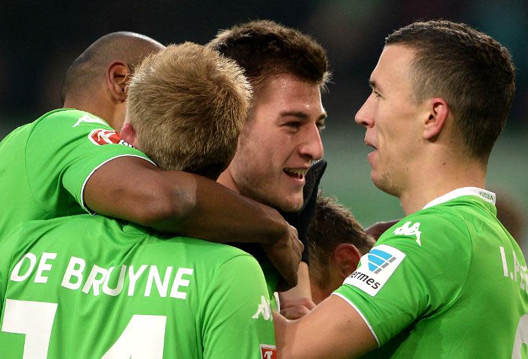 Robin Knoche (centre) celebrates with teammates after scoring the winner in Wolsburg's 1-0 victory over Borussia Moenchengladbach in Wolfsburg on Sunday