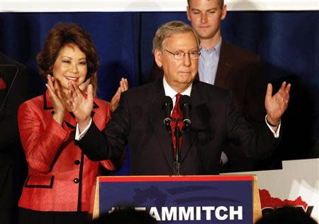 U.S. Senate Republican Leader Sen. Mitch McConnell (R-KY) and his wife Elaine Chao address a crowd of campaign supporters after defeating Tea Party challenger Matt Bevin in the states Republican primary elections in Louisville, Kentucky, May 20, 2014. REUTERS/John Sommers II