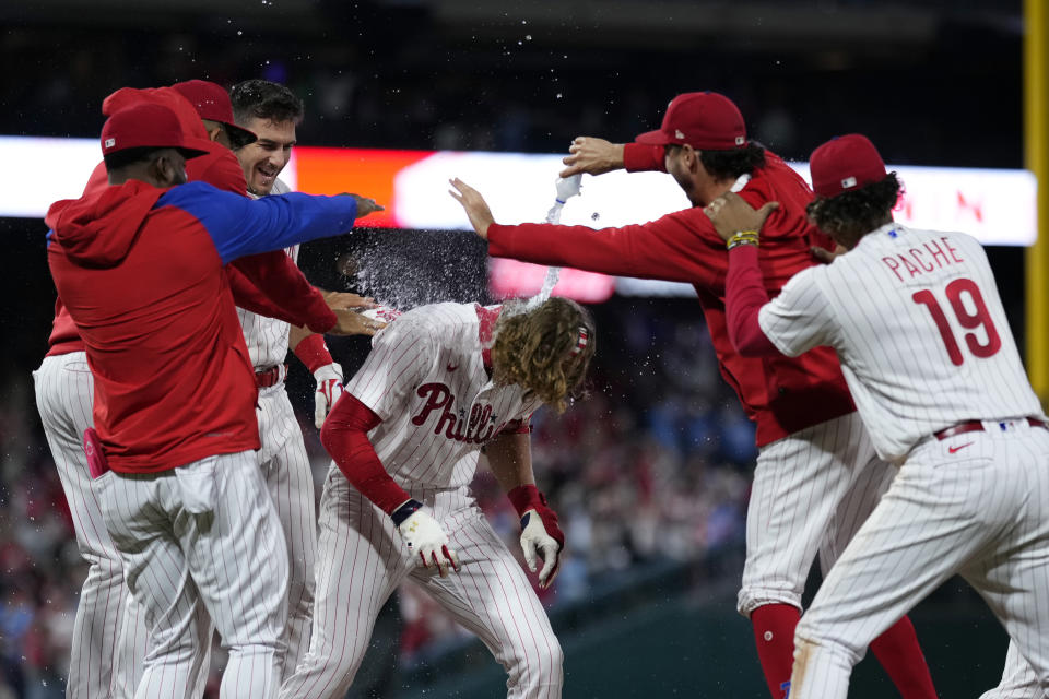 Philadelphia Phillies' Alec Bohm celebrates with teammates after hitting the game-winning run-scoring single against New York Mets pitcher Adam Ottavino during the 10th inning of a baseball game, Friday, Sept. 22, 2023, in Philadelphia. (AP Photo/Matt Slocum)