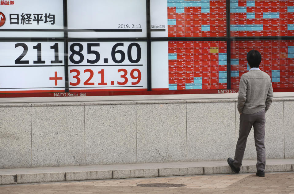 A man looks at an electronic stock board showing Nikkei Stock index, at a securities firm in Tokyo, Wednesday, Feb. 13, 2019. Asian shares were mostly higher Wednesday, cheered by prospects for a resolution to the costly trade dispute between the U.S. and China, which had also sent Wall Street indexes higher. (AP Photo/Koji Sasahara)