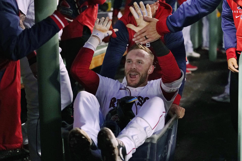 Boston Red Sox's Trevor Story is congratulated after his second two-run home run of the night, during the third inning of the team's baseball game against the Seattle Mariners at Fenway Park, Thursday, May 19, 2022, in Boston. (AP Photo/Charles Krupa)