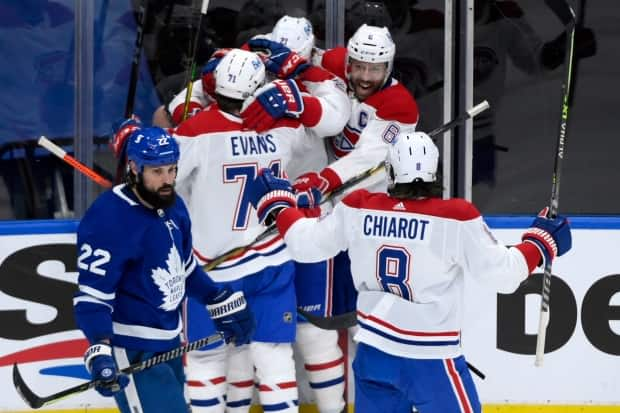 Montreal Canadiens players celebrate a goal by forward Brendan Gallagher during the team's 3-1 win over the Toronto Maple Leafs on Monday. (Nathan Denette/The Canadian Press - image credit)