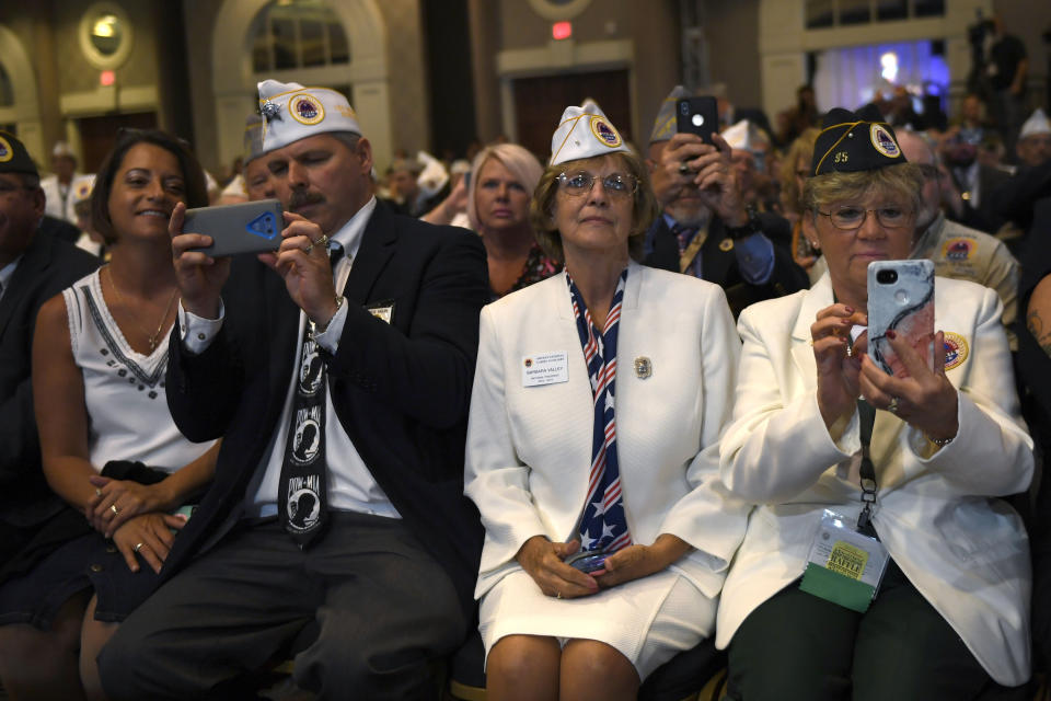 People listen as President Donald Trump speaks at the American Veterans (AMVETS) 75th National Convention in Louisville, Ky., Wednesday, Aug. 21, 2019. (AP Photo/Susan Walsh)