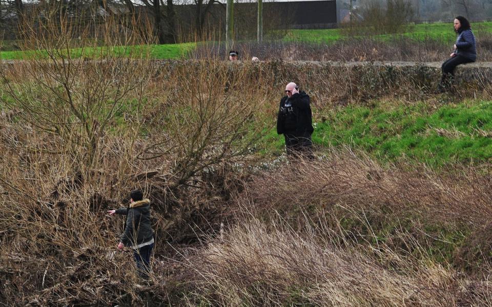 Dogwalkers point to location on the banks of the River Wyre where they believed they had found the body of Nicola Bulley - Chris Neill