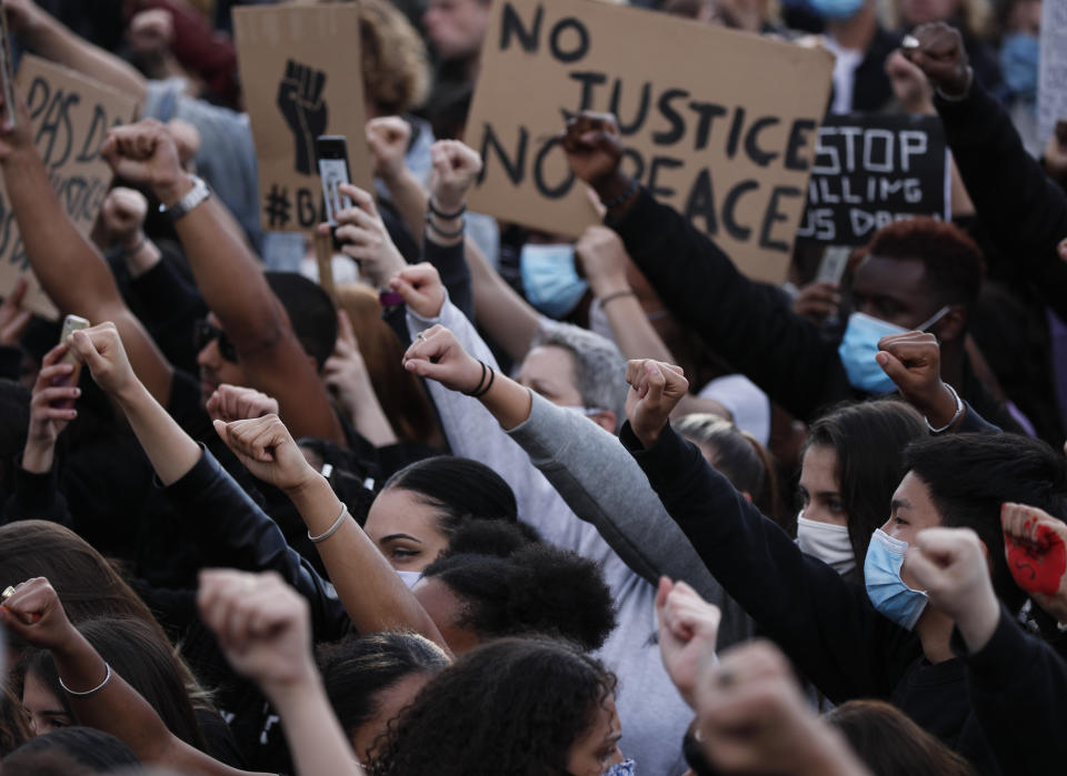 Clenched fists are raised during a demonstration in Paris, France, Saturday, June 6, 2020, to protest against the recent killing of George Floyd, a black man who died in police custody in Minneapolis, U.S.A., after being restrained by police officers on May 25, 2020. Further protests are planned over the weekend in European cities, some defying restrictions imposed by authorities because of the coronavirus pandemic. (AP Photo/Francois Mori)