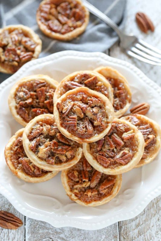 <p>Live Well Bake Often</p><p>These mini pecan pies are easy to make and can also be made ahead of time. These are the perfect mini treat for Thanksgiving too!</p><p><strong>Get the recipe: <a href="https://www.livewellbakeoften.com/mini-pecan-pies/" rel="nofollow noopener" target="_blank" data-ylk="slk:Mini Pecan Pies;elm:context_link;itc:0;sec:content-canvas" class="link rapid-noclick-resp">Mini Pecan Pies</a></strong></p>