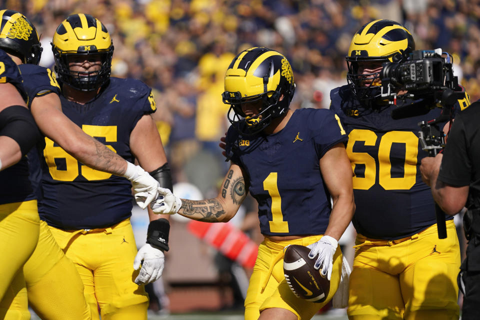 Michigan wide receiver Roman Wilson (1) celebrates his touchdown reception against UNLV in the first half of an NCAA college football game in Ann Arbor, Mich., Saturday, Sept. 9, 2023. (AP Photo/Paul Sancya)