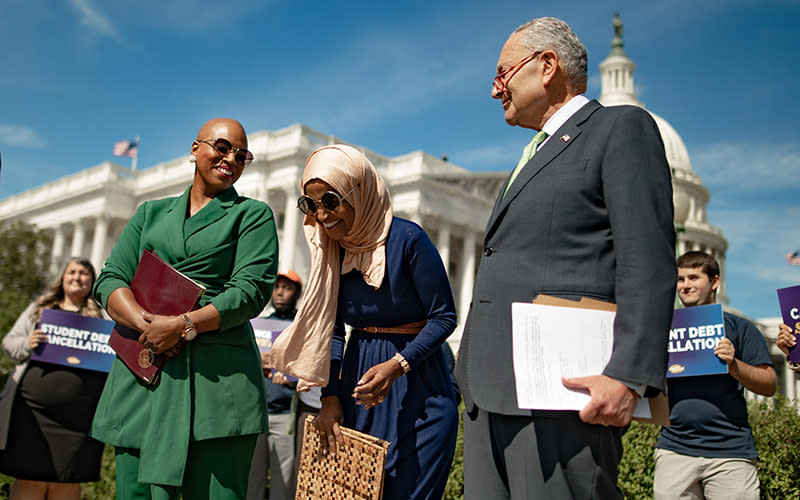 Reps. Ayanna Pressley (D-Mass.), from left, and Ilhan Omar (D-Minn.) laugh as Senate Majority Leader Charles Schumer (D-N.Y.) arrives for a press conference