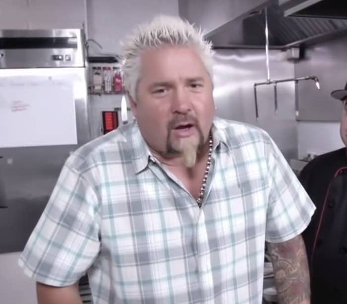 Guy Fieri in a restaurant kitchen